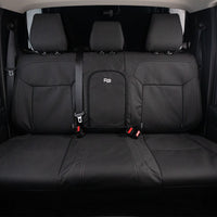 the back seats of a car with black cloth