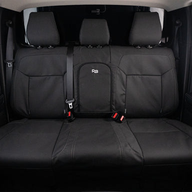 the back seats of a car with black cloth